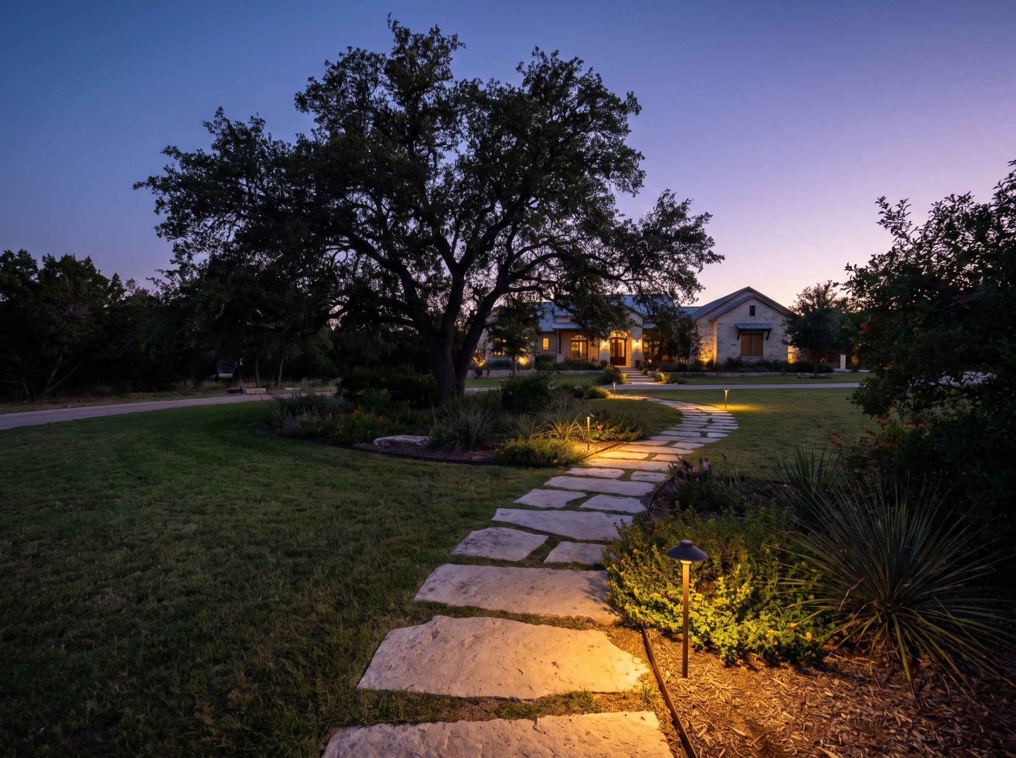 Low walkway lighting along a stone path at dusk
