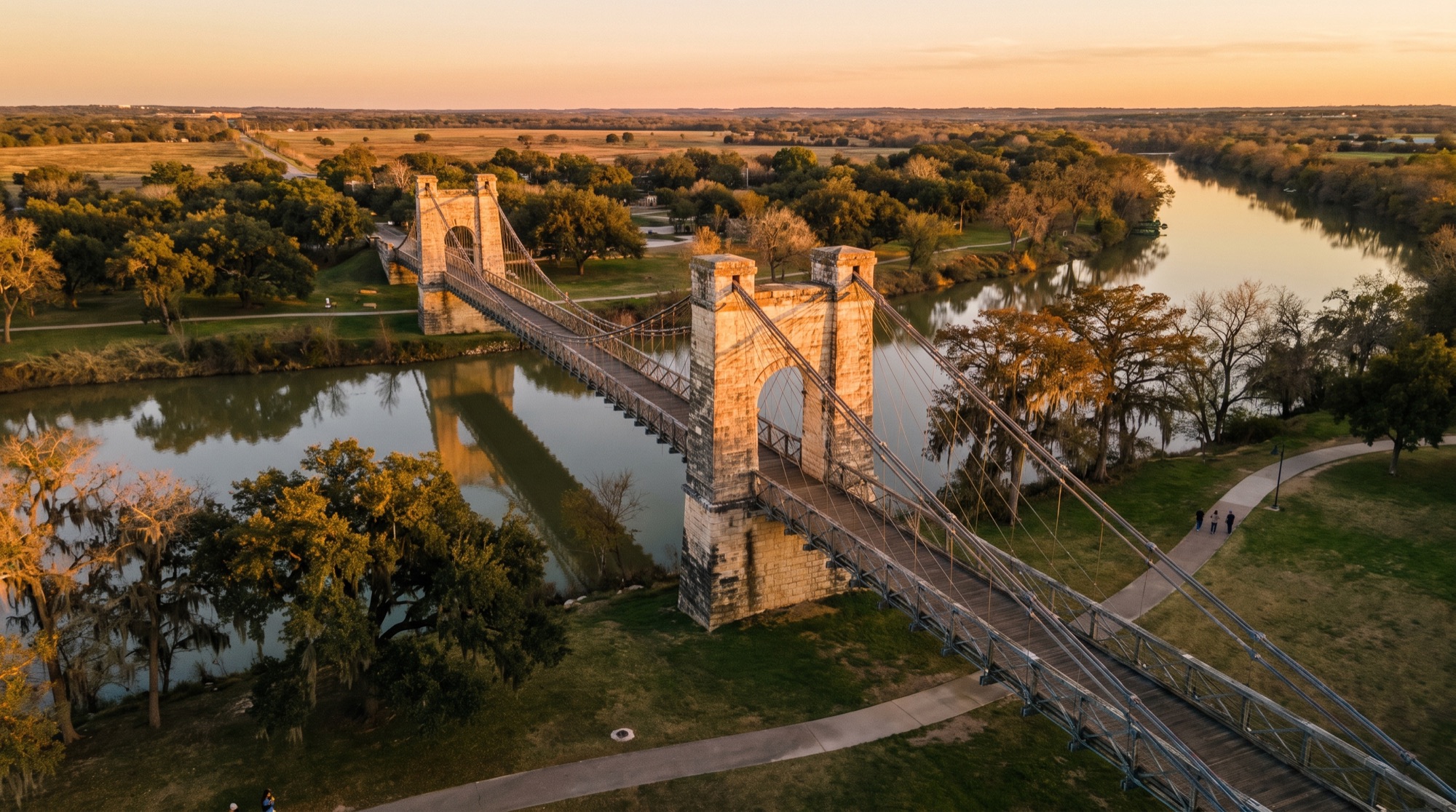 Waco's historic suspension bridge over the Brazos River at golden hour
